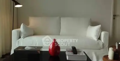 Elegant living room with white sofa and modern decor, perfect for relaxation and style.