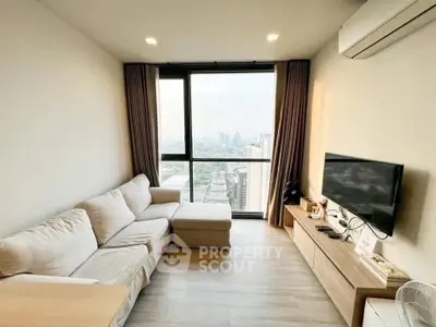Modern living room with city view, cozy sofa, and sleek entertainment setup.