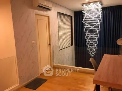 Modern study room with elegant chandelier and wooden flooring