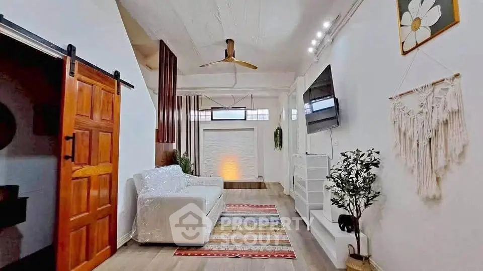 Stylish living room with modern decor, wooden accents, and cozy seating area.