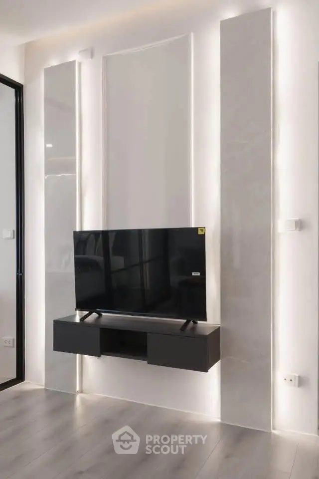 Modern living room with sleek TV setup and elegant wall design