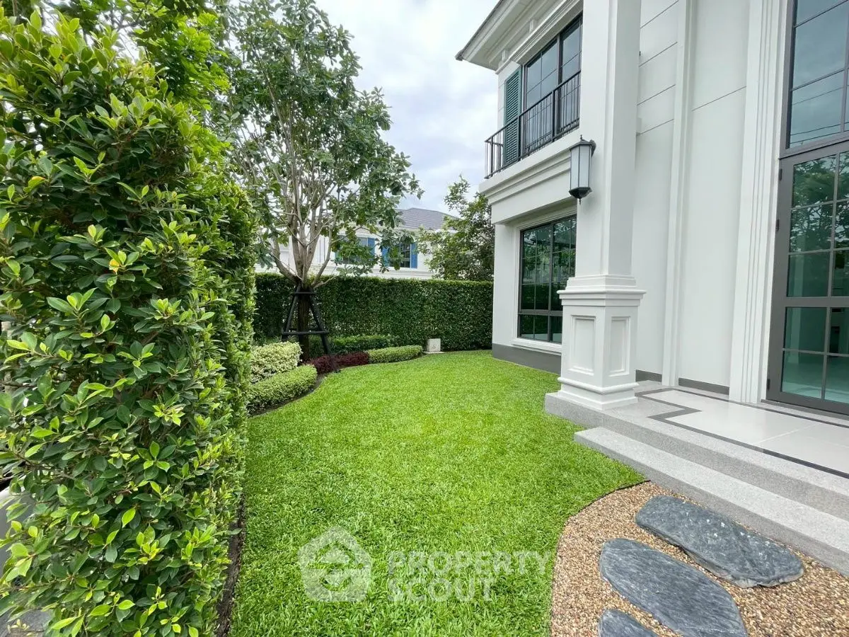 Luxurious garden view of modern home with lush greenery and elegant architecture.
