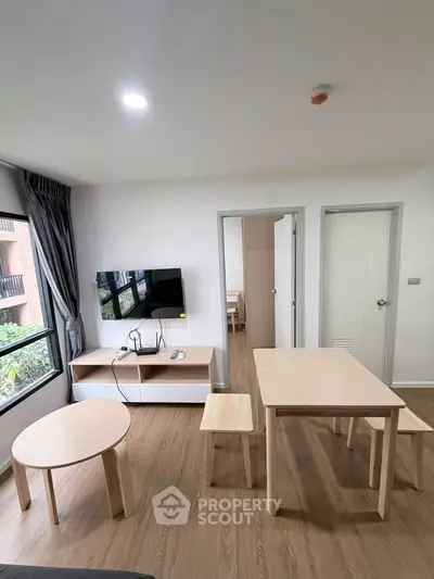 Modern living room with wooden furniture and large window view