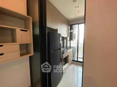 Modern kitchen with sleek appliances and balcony view in a stylish apartment.