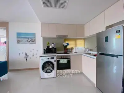 Modern kitchen with sleek appliances and stylish decor in a contemporary apartment.