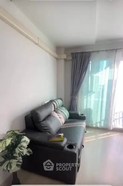 Cozy living room with modern sofa and large window for natural light