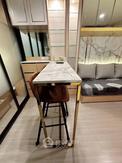 Modern interior with sleek marble table and stylish seating in a contemporary living space.