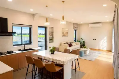 Spacious open-plan living room with modern kitchen and stylish decor