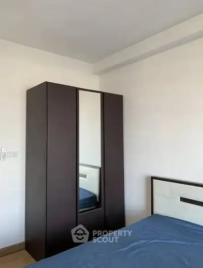 Minimalist bedroom with sleek wardrobe and bed, perfect for modern living.