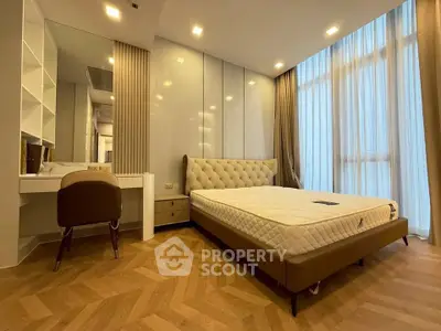 Luxurious bedroom with elegant design and natural light, featuring a stylish bed and modern decor.