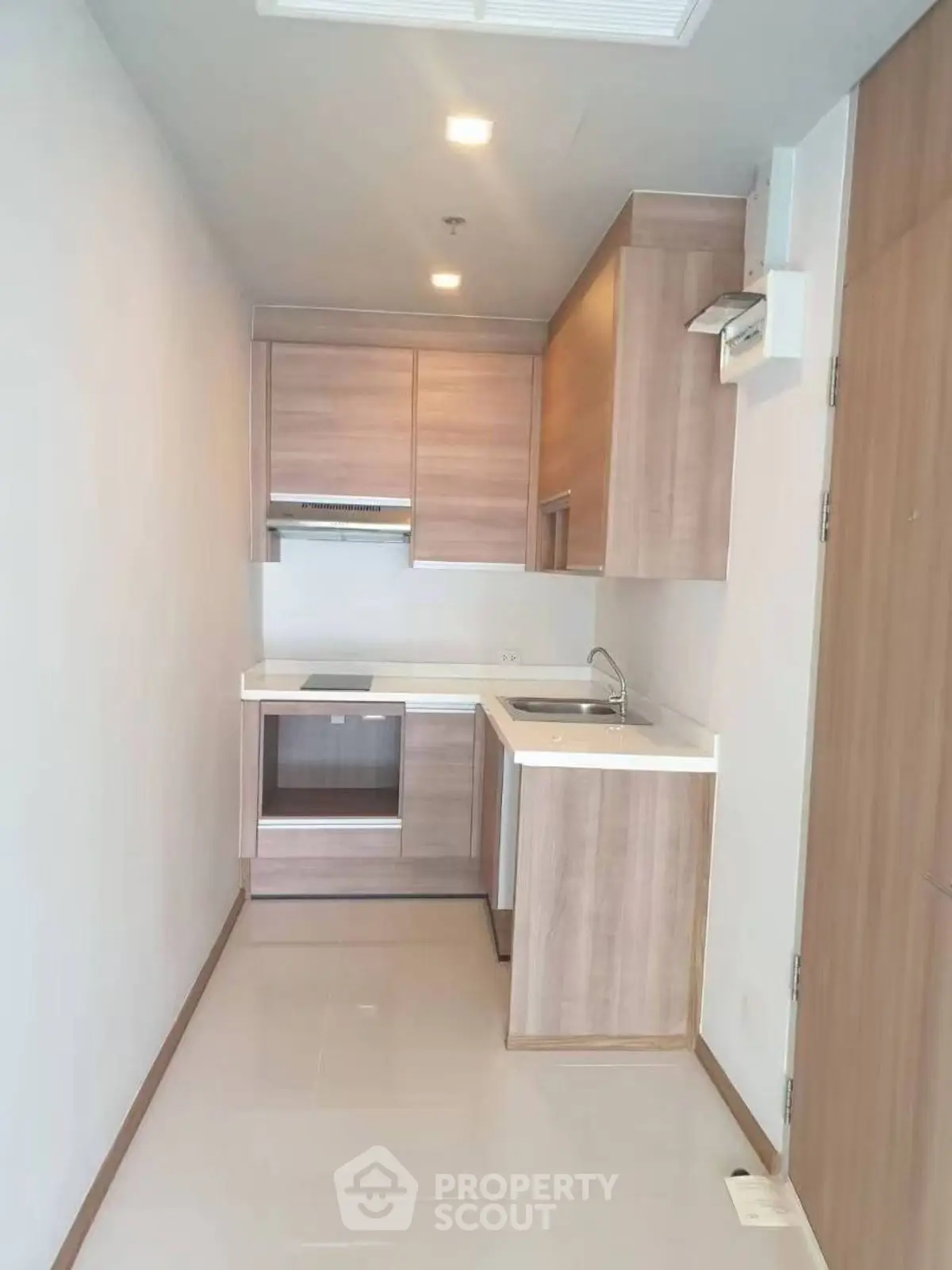 Modern compact kitchen with wooden cabinets and sleek design