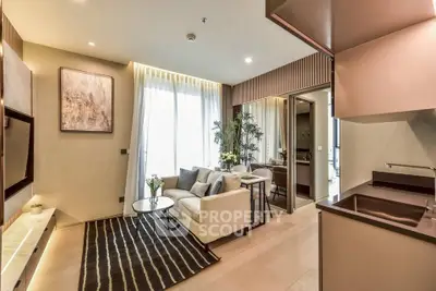 Modern living room with elegant decor and open kitchen layout