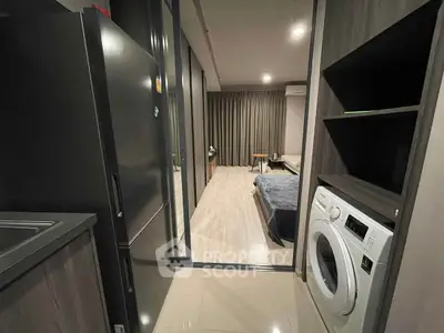 Modern apartment with sleek kitchen and cozy bedroom view