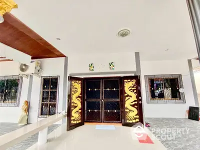 Elegant entrance with ornate dragon-themed doors and modern design