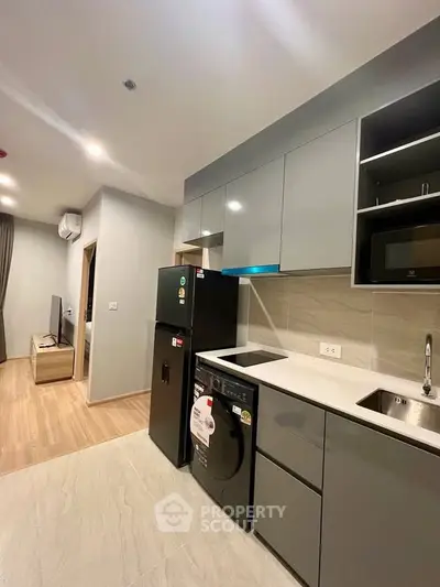 Modern kitchen with sleek cabinetry and integrated appliances in a stylish apartment.