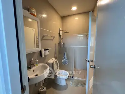 Modern bathroom with sleek fixtures and glass shower enclosure