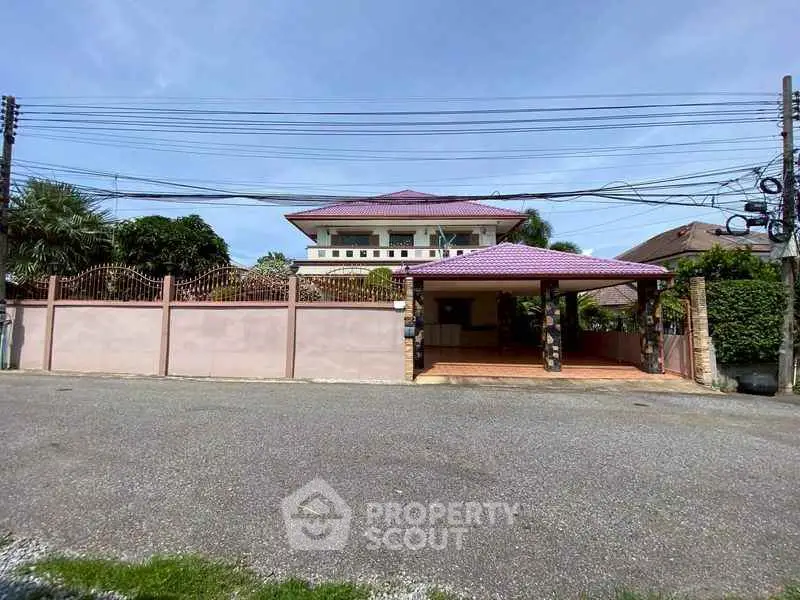 Spacious two-story house with gated entrance and tiled roof