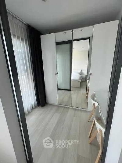 Modern bedroom with mirrored wardrobe and stylish decor