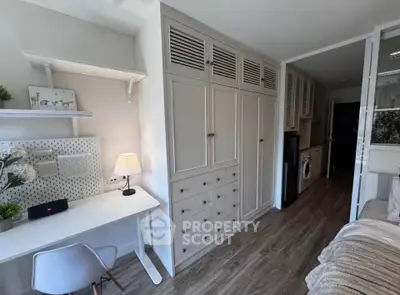 Chic study room with modern desk and ample storage in stylish apartment.