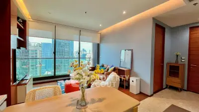 Modern living room with city view, stylish decor, and natural light