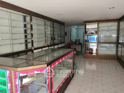 Spacious commercial retail space with glass display cabinets and tiled flooring, ideal for showcasing products.
