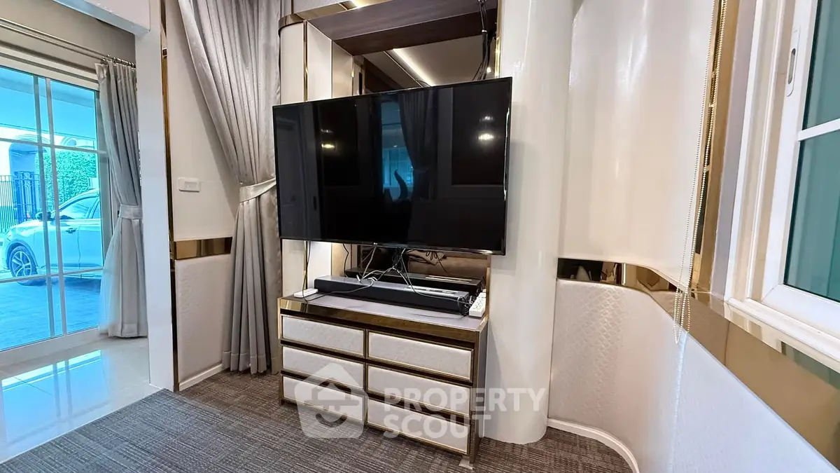 Luxurious living room with modern TV setup and elegant decor