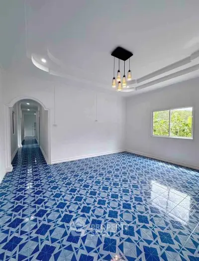 Spacious interior with vibrant blue patterned floor tiles and modern lighting