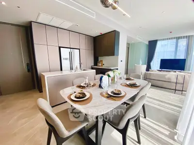 Luxurious open-layout kitchen and dining area with modern appliances and elegant decor.
