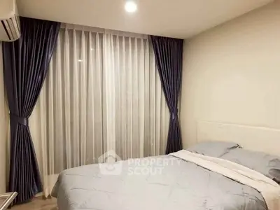 Cozy bedroom with elegant curtains and soft lighting, perfect for relaxation and comfort.