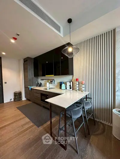 Modern kitchen with sleek design, featuring open layout and stylish lighting, perfect for contemporary living.