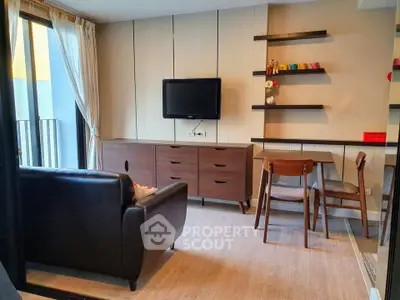 Modern living room with stylish furniture and wall-mounted TV in a cozy apartment setting.
