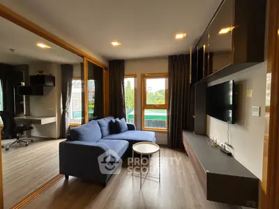 Modern living room with sleek furniture and large windows offering natural light and a view.