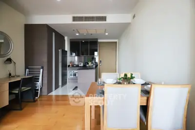 Modern open-plan living and dining area with sleek kitchen and stylish decor.