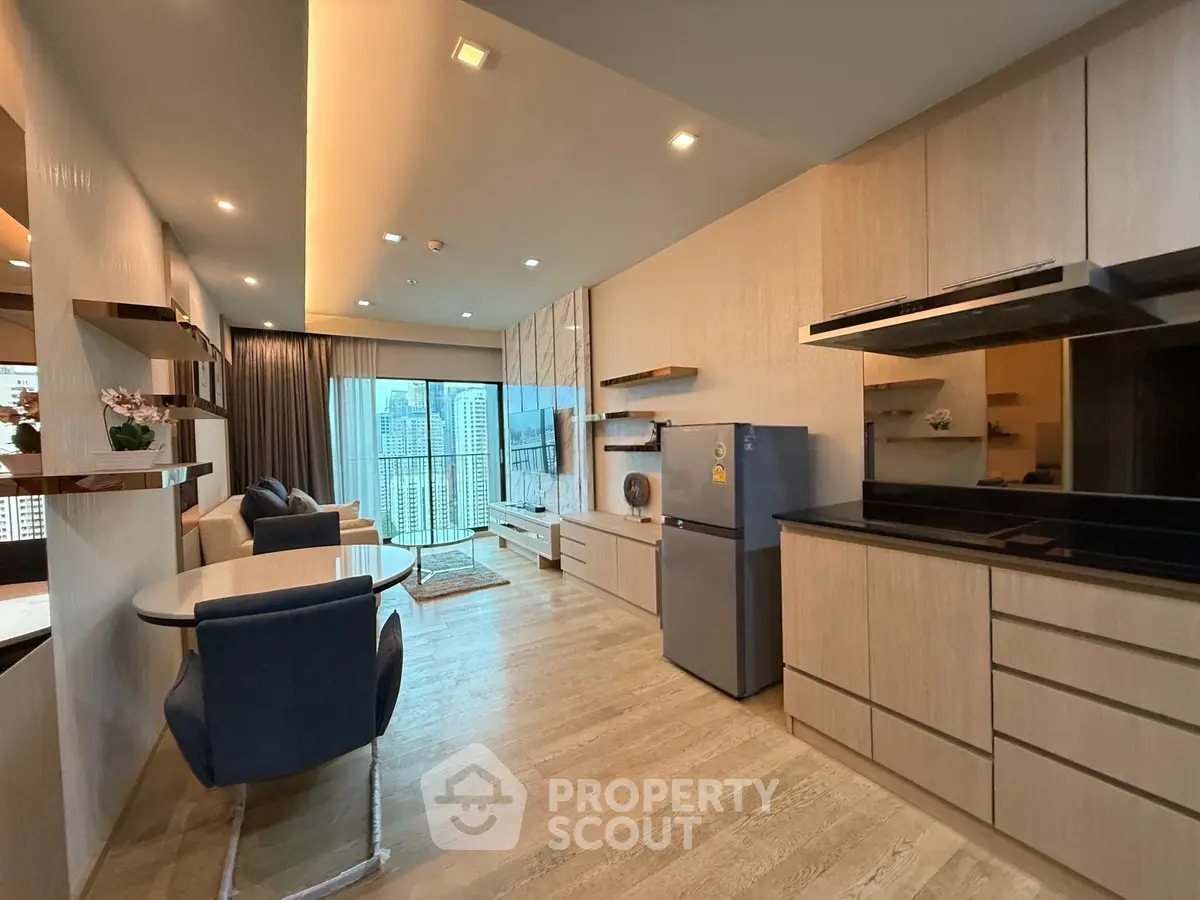 Modern open-layout living room with kitchen, featuring sleek design and city view balcony.