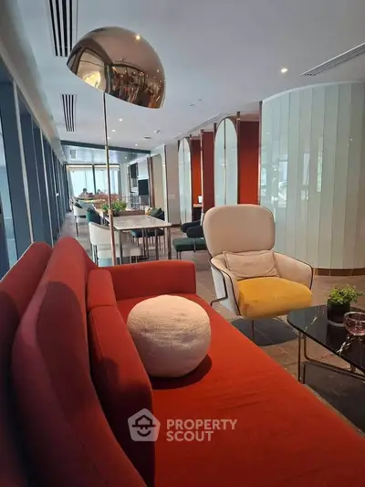 Modern living room with stylish furniture and large windows offering natural light.