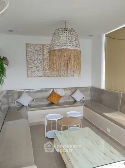 Stylish modern living room with unique lighting and cozy seating area, perfect for relaxation and entertaining.