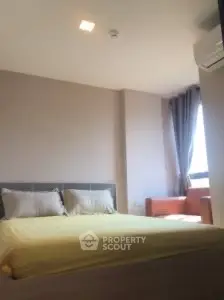 Cozy bedroom with natural light and modern furnishings in a stylish apartment.