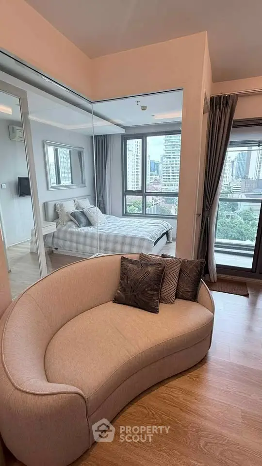 Modern apartment with cozy living area and city view from bedroom