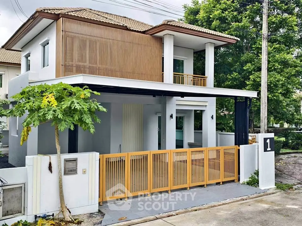 Modern two-story house with stylish wooden accents and spacious balcony in a serene neighborhood.