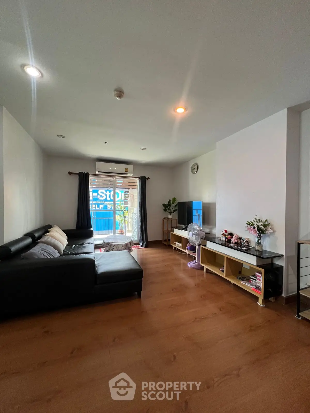 Spacious living room with modern decor and large window for natural light.