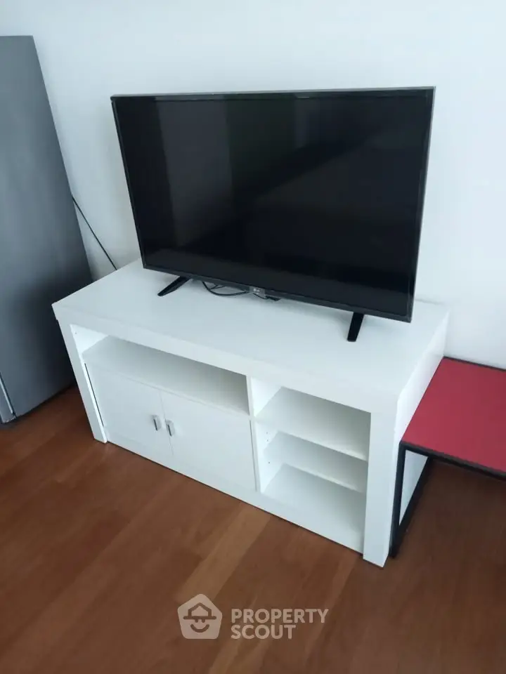 Modern living room with sleek TV stand and flat-screen television