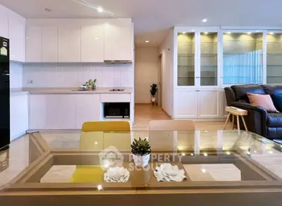 Modern open-plan living room with sleek kitchen and stylish decor