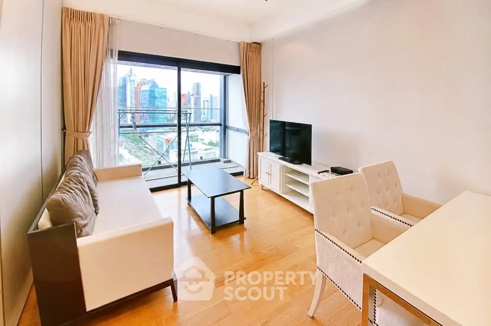 Spacious living room with city view, elegant furniture, and large windows in modern apartment.