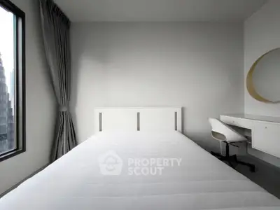 Modern minimalist bedroom with white furniture and large window view.