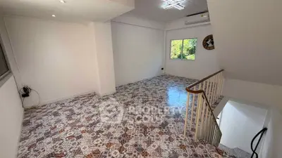 Spacious living room with patterned tile flooring and natural light