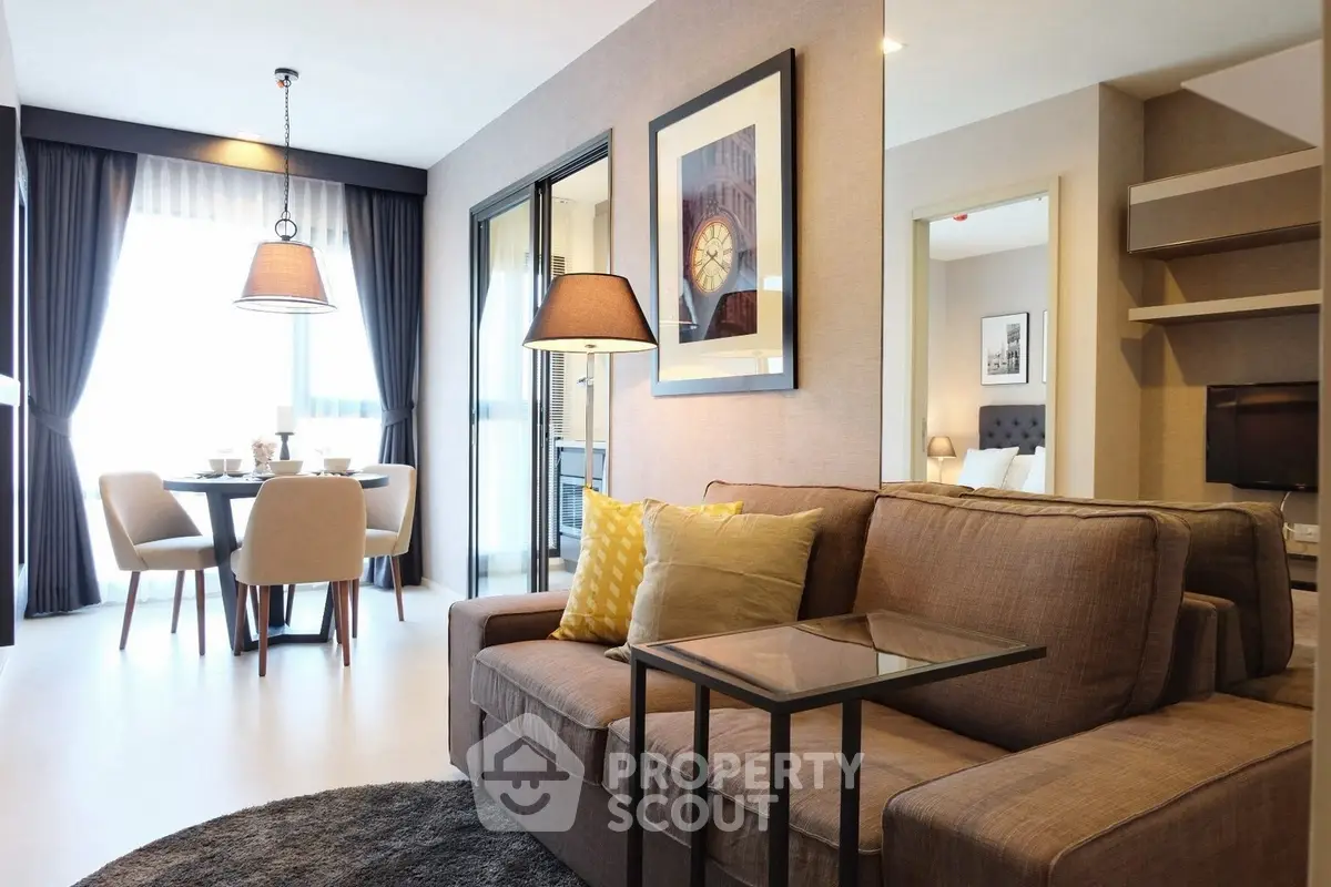 Modern living room with stylish decor and dining area in open layout apartment.