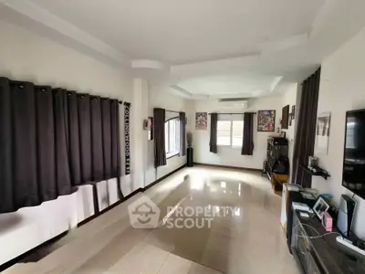 Spacious living room with modern decor and large windows for natural light