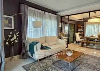 Elegant living room with modern decor and spacious dining area