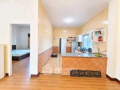 Spacious open-layout kitchen with adjacent bedroom in modern apartment