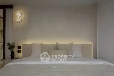 Luxurious bedroom with elegant lighting and plush bedding, perfect for relaxation.